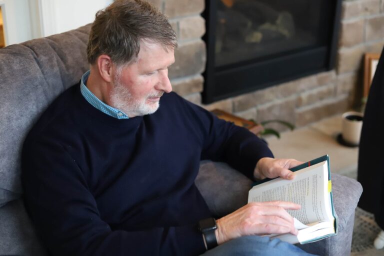 Author Dee Gibson reading his Bible.